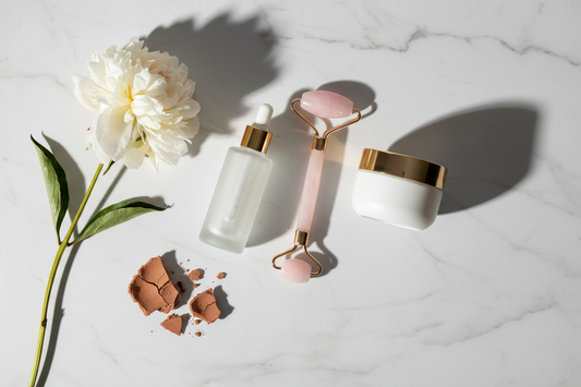 Woman examining skin in mirror — common skincare mistakes that affect your glow — Glow Fit Essentials